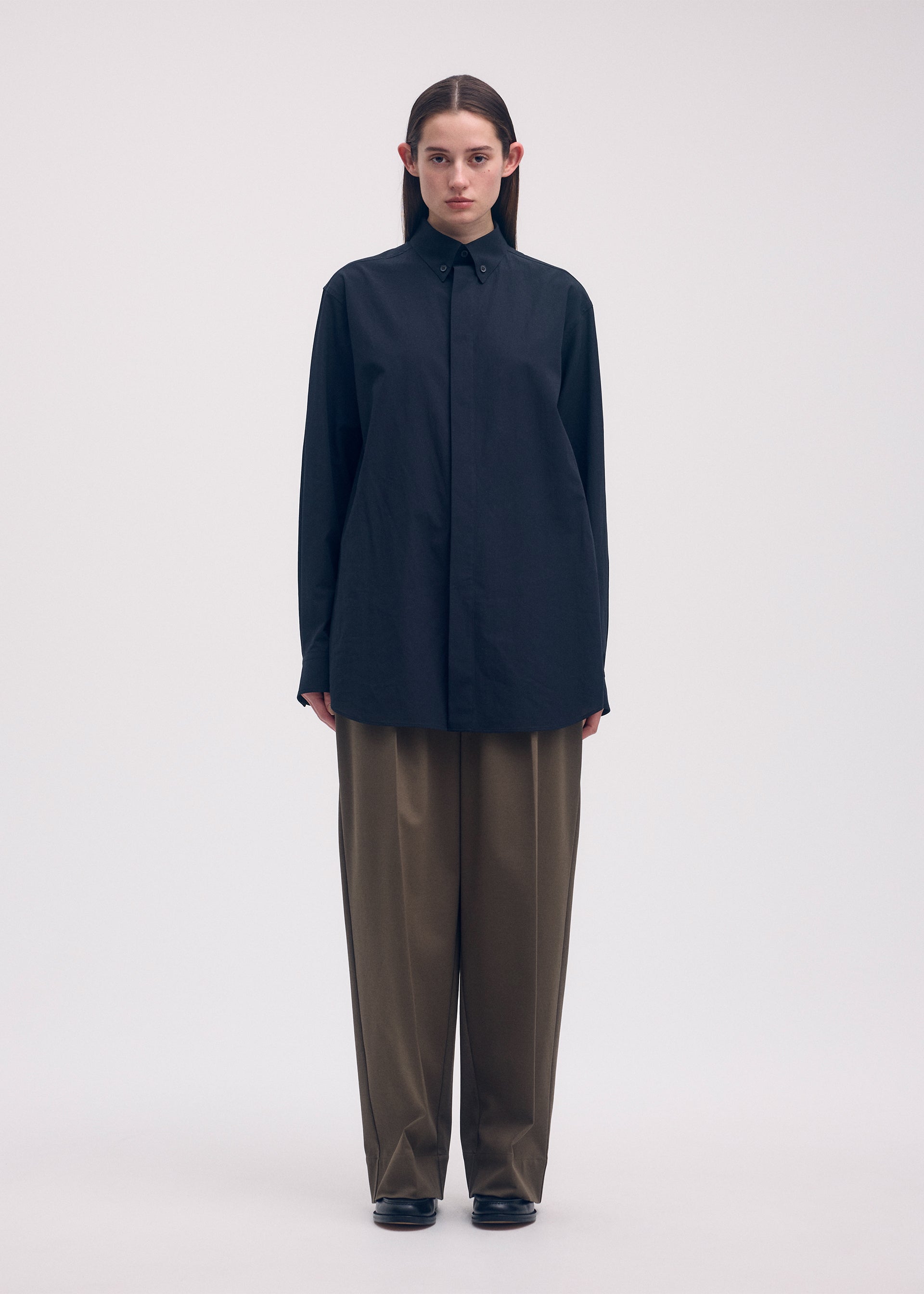 A model wears the ISSEY MIYAKE ODD SHIRT shirt.