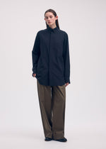 A model wears the ISSEY MIYAKE ODD SHIRT shirt.