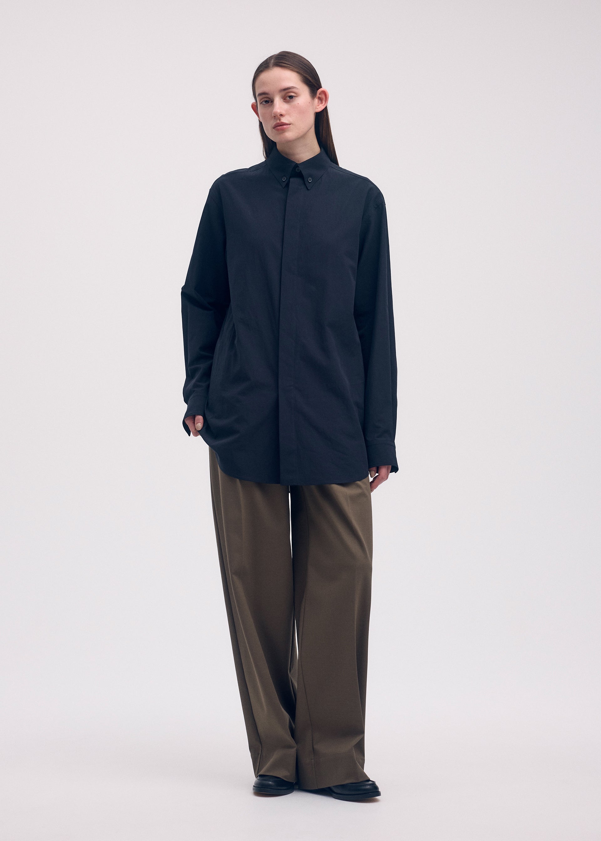 A model wears the ISSEY MIYAKE ODD SHIRT shirt.