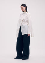 A model wears the ISSEY MIYAKE ODD SHIRT shirt.