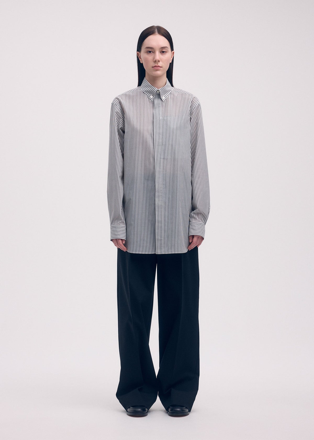 A model wears the ISSEY MIYAKE ODD SHIRT (STRIPES) shirt.