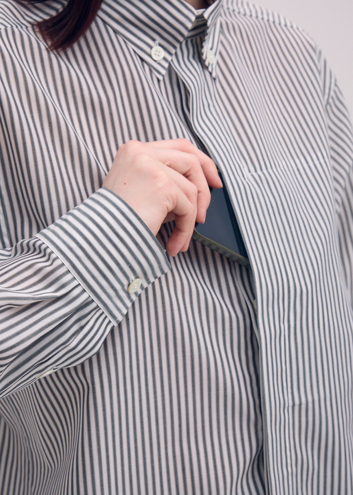 A model wears the ISSEY MIYAKE ODD SHIRT (STRIPES) shirt.