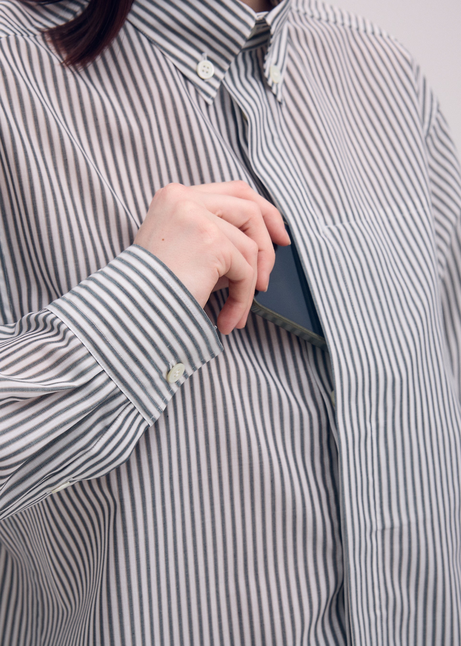 A model wears the ISSEY MIYAKE ODD SHIRT (STRIPES) shirt.