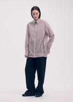 A model wears the ISSEY MIYAKE ODD SHIRT (STRIPES) shirt.