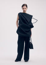 A model wears the ISSEY MIYAKE PAPER BAG shirt.