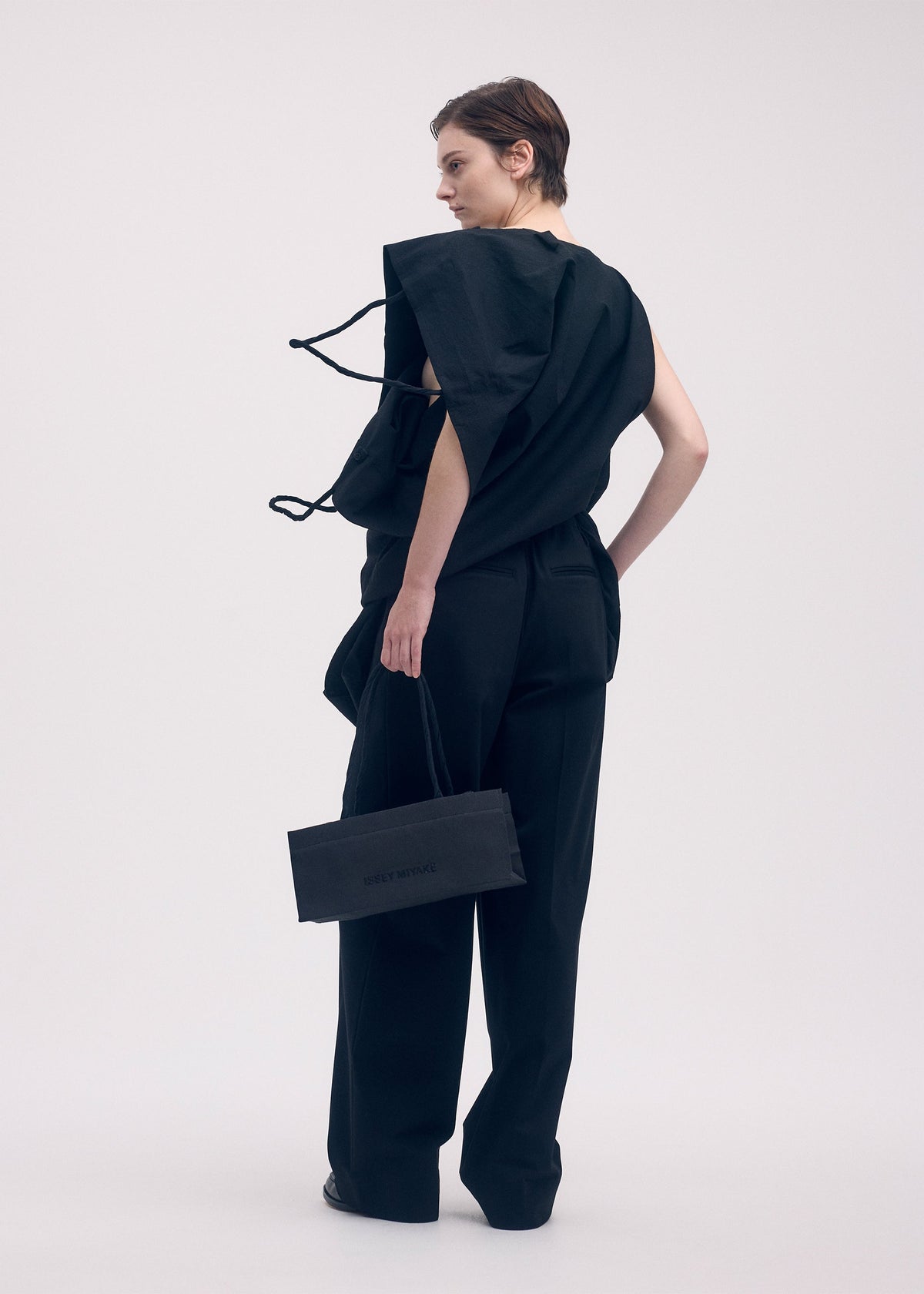 A model wears the ISSEY MIYAKE PAPER BAG shirt.