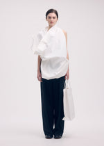 A model wears the ISSEY MIYAKE PAPER BAG shirt.