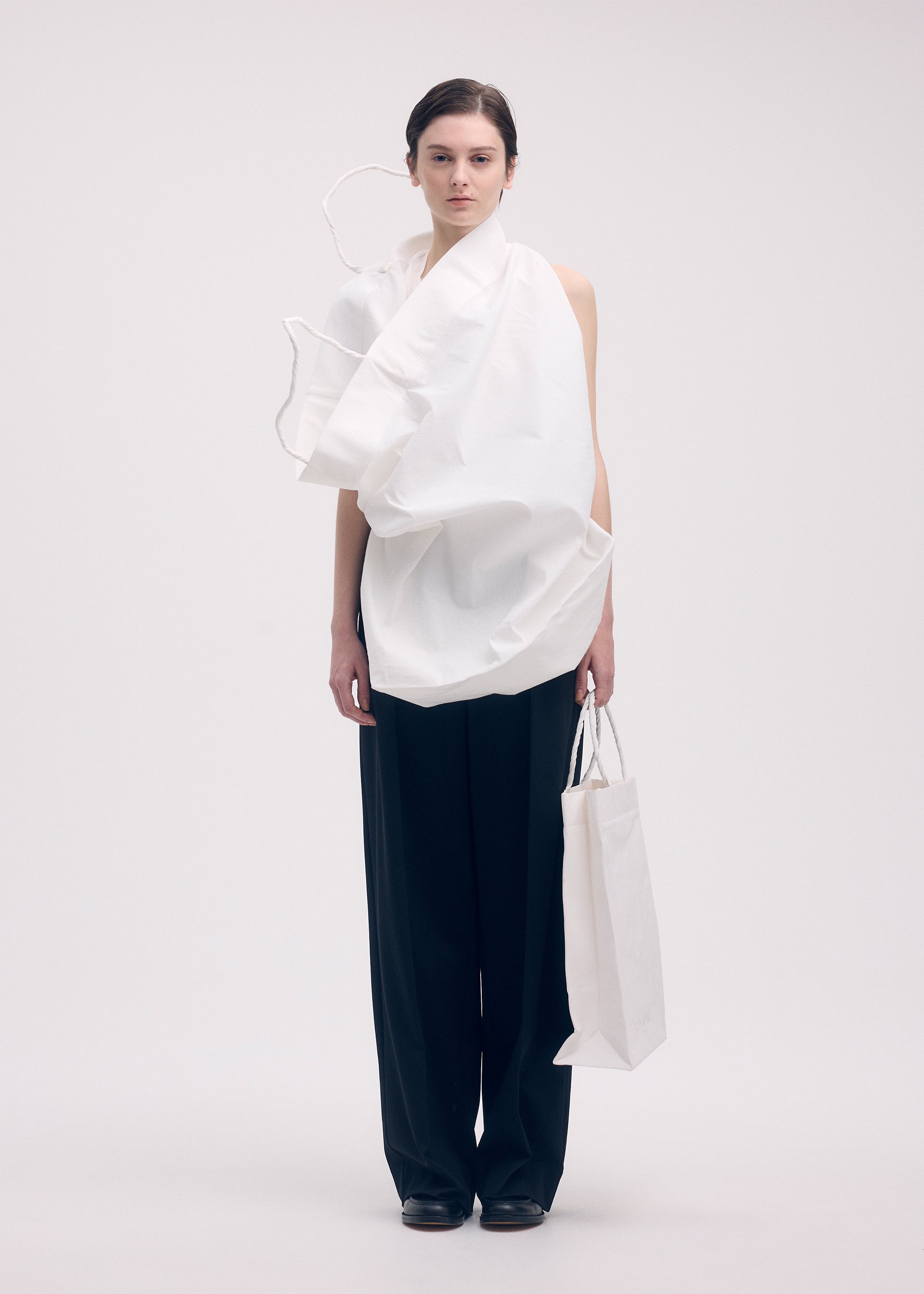 A model wears the ISSEY MIYAKE PAPER BAG shirt.