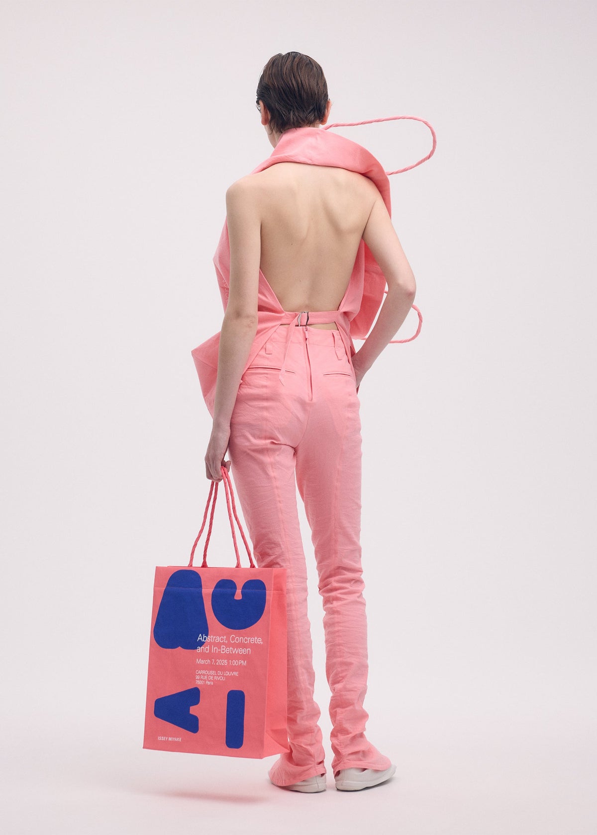 A model wears the ISSEY MIYAKE PAPER BAG (POSTER) shirt.
