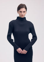 A model wears the ISSEY MIYAKE SLEEK PLEATS shirt.