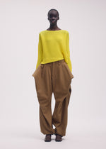 A model wears the ISSEY MIYAKE SHIFTED MISTY PLEATS clothing.