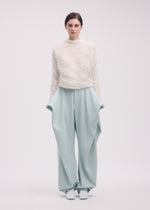 A model wears the ISSEY MIYAKE SHIFTED FUZZY PLEATS shirt.