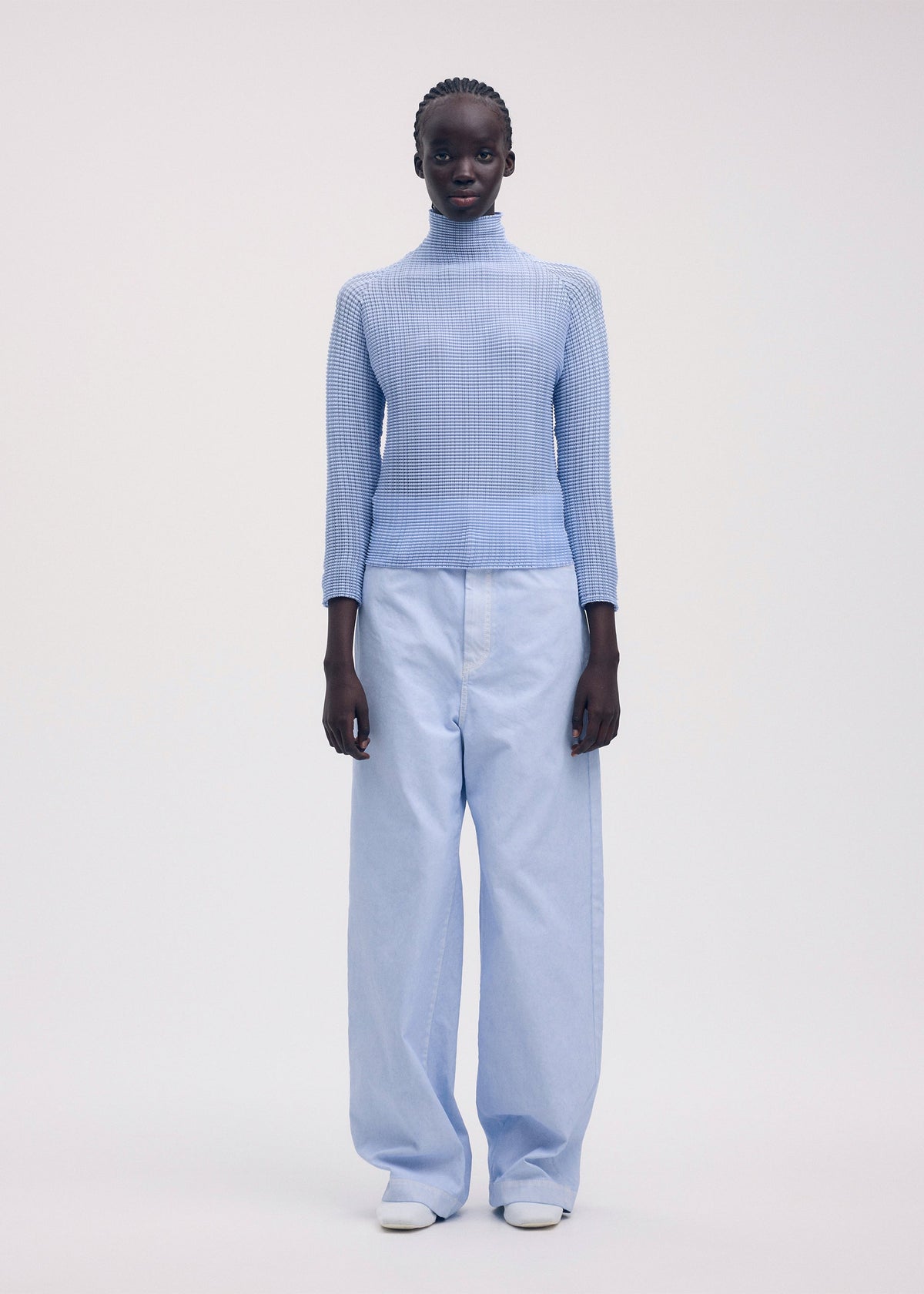 A model wears the ISSEY MIYAKE WOOLY PLEATS 58 shirt.