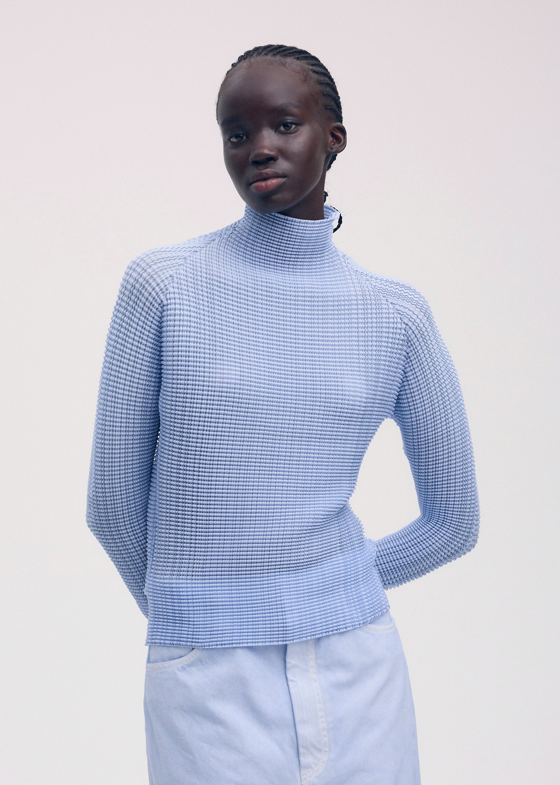 A model wears the ISSEY MIYAKE WOOLY PLEATS 58 shirt.