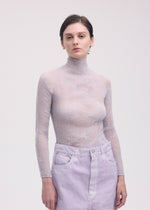 A model wears the ISSEY MIYAKE CHIFFON TWIST 1 top.