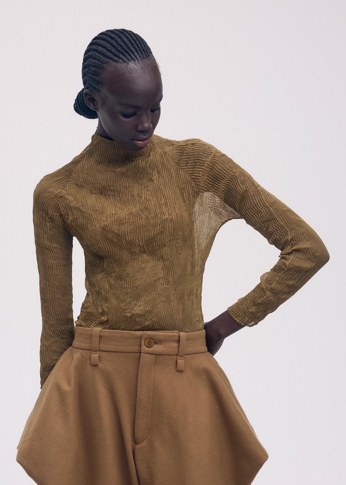 A model wears the ISSEY MIYAKE CHIFFON TWIST 3 clothing.