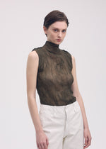 A model wears the ISSEY MIYAKE CHIFFON TWIST 1 top.