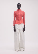 A model wears the ISSEY MIYAKE CHIFFON TWIST 1 top.
