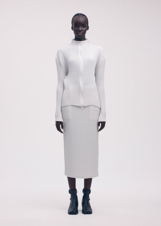 A model wears the ISSEY MIYAKE SLEEK PLEATS cardigan.