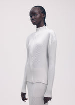 A model wears the ISSEY MIYAKE SLEEK PLEATS cardigan.