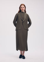 A model wears the ISSEY MIYAKE SOFT FOLD PLEATS cardigan.