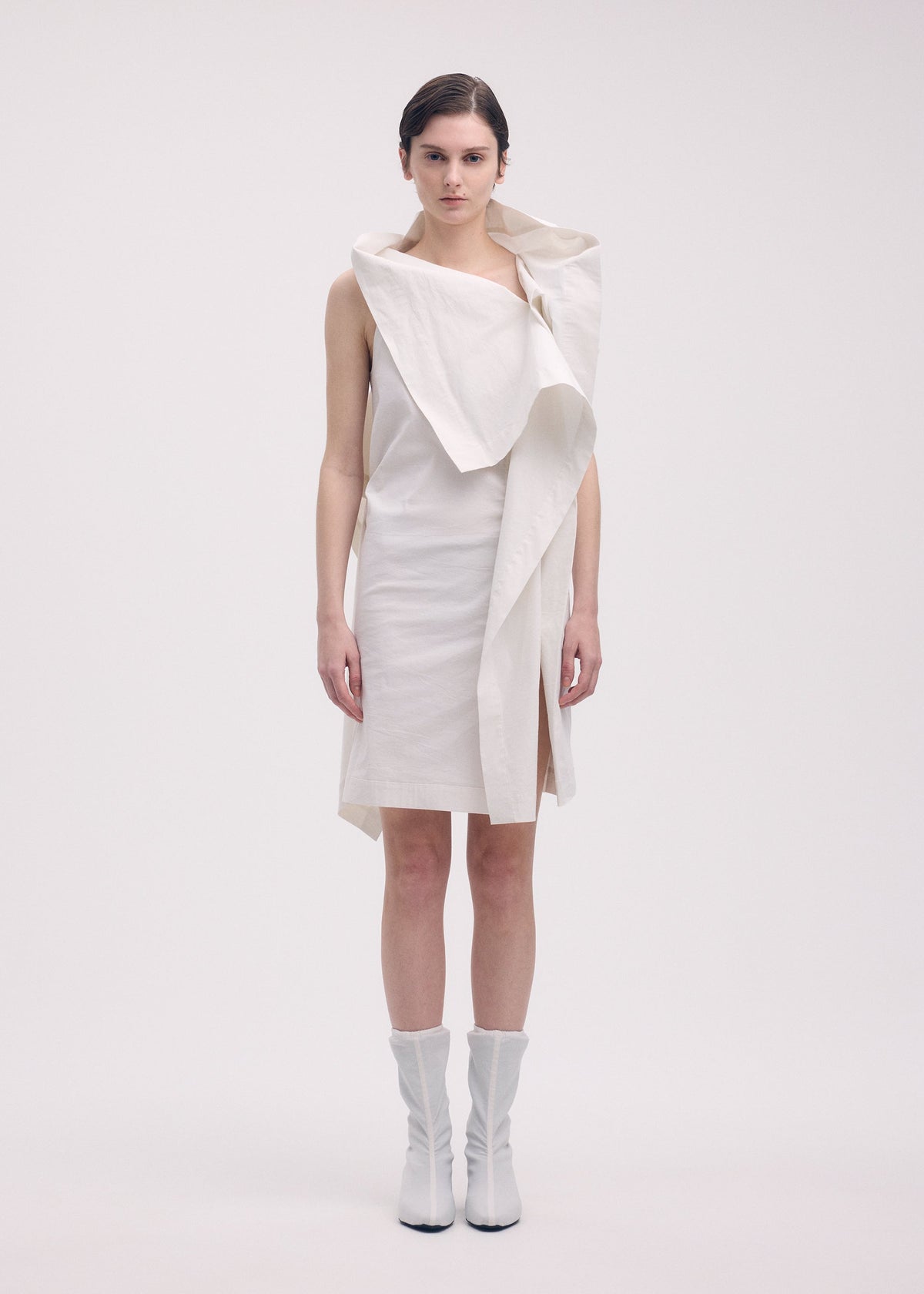 A model wears the ISSEY MIYAKE COLLAPSING SCULPTURE tunic.