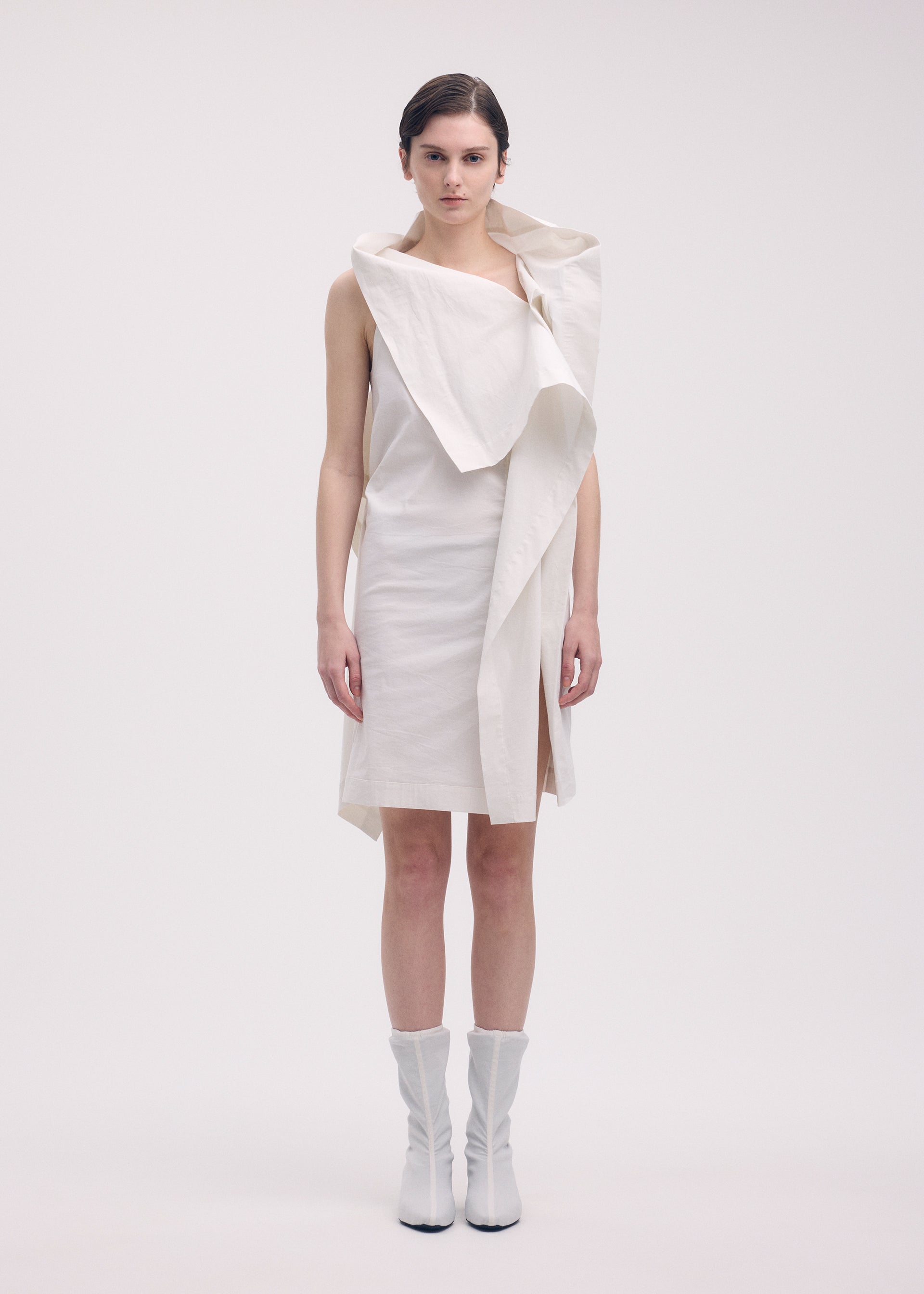 A model wears the ISSEY MIYAKE COLLAPSING SCULPTURE tunic.