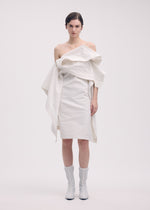 A model wears the ISSEY MIYAKE COLLAPSING SCULPTURE tunic.