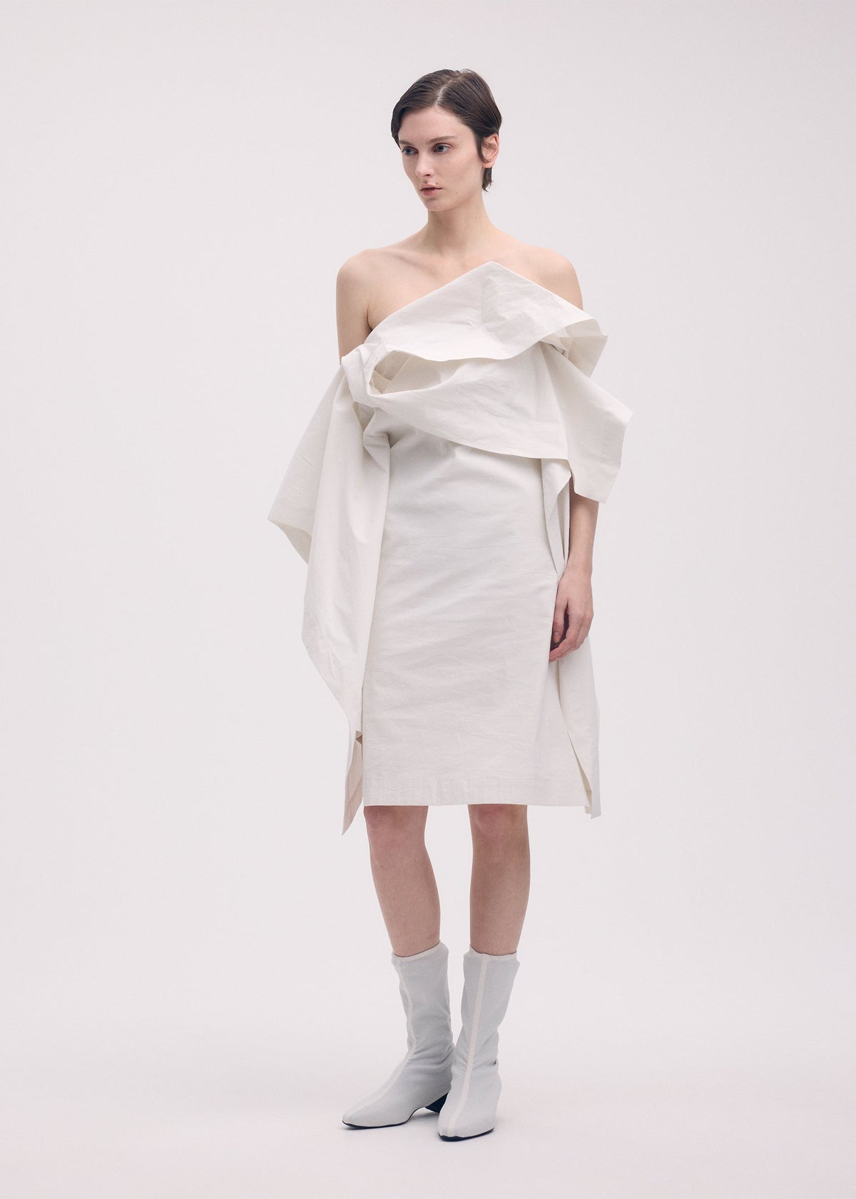 A model wears the ISSEY MIYAKE COLLAPSING SCULPTURE tunic.