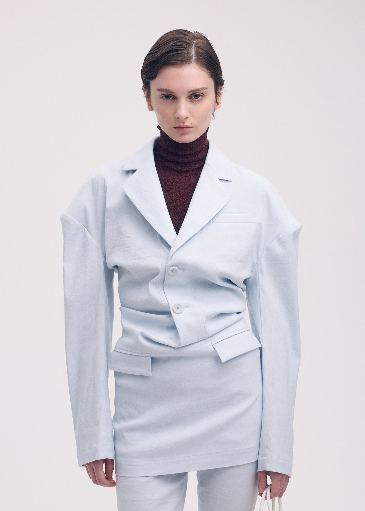 A model wears the ISSEY MIYAKE LIKE TORSO LIKE BLAZER tunic.