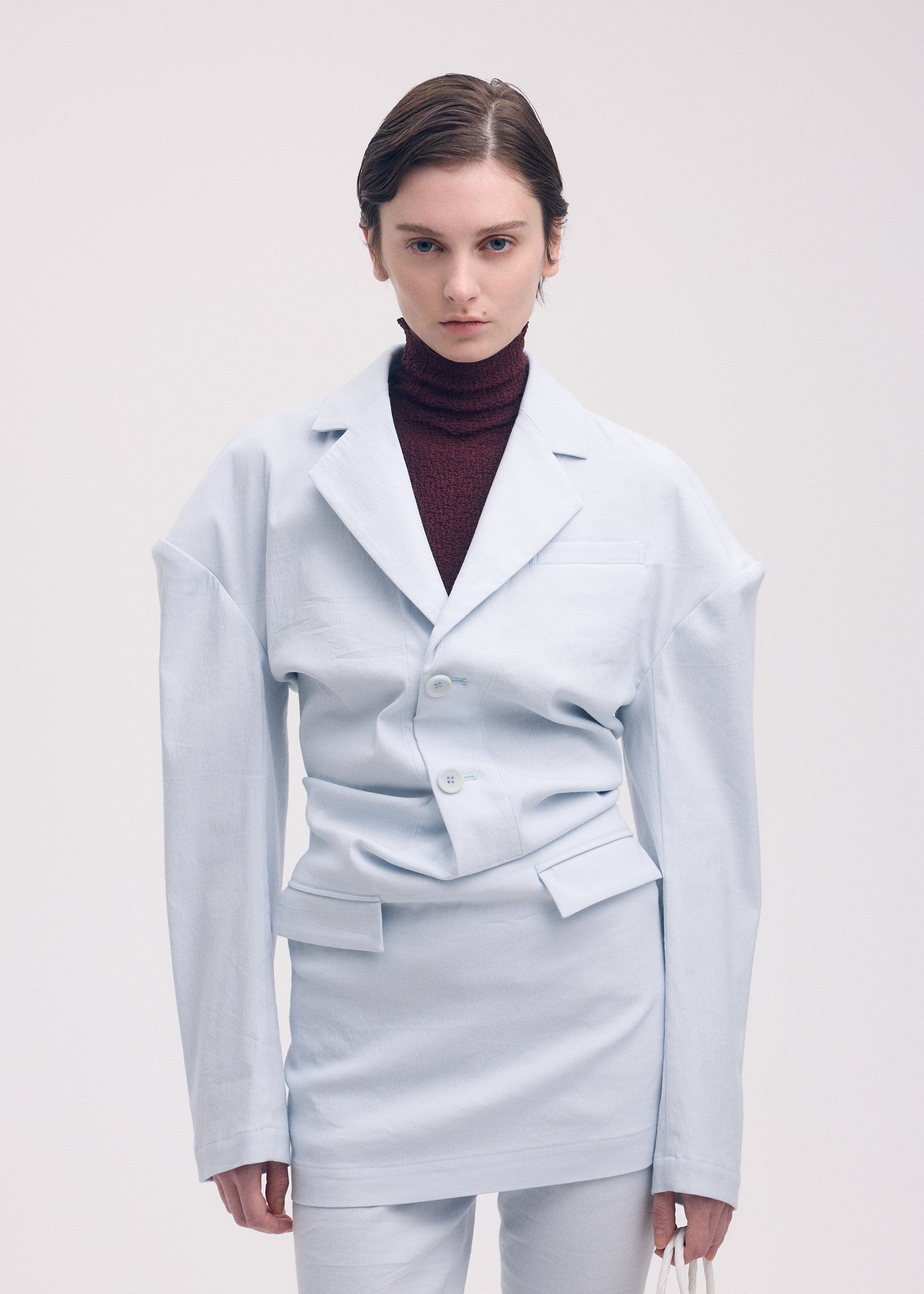 A model wears the ISSEY MIYAKE LIKE TORSO LIKE BLAZER tunic.