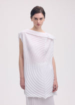A model wears the ISSEY MIYAKE PAPER BAG PLEATS tunic.