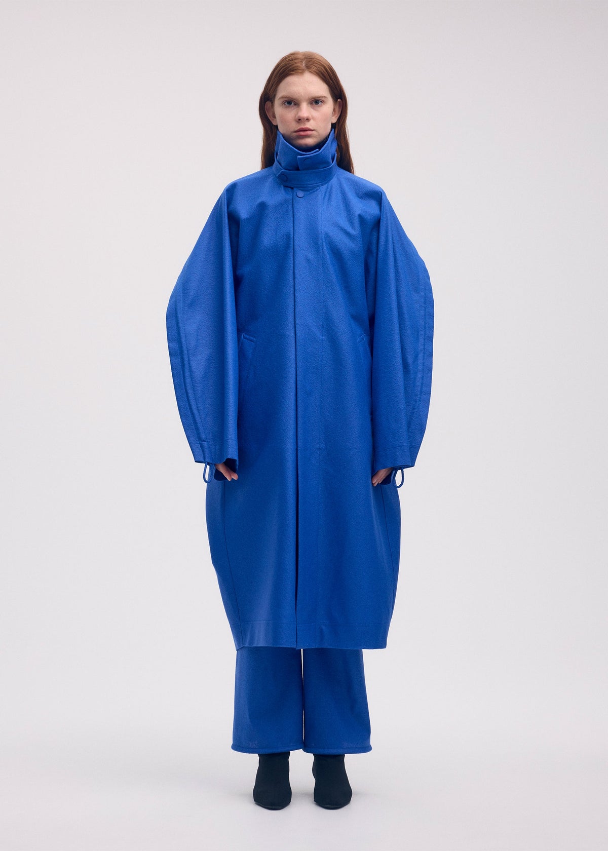 A model wears the ISSEY MIYAKE HANG OR CARRY coat.