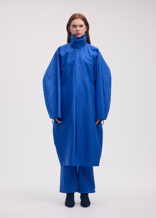 A model wears the ISSEY MIYAKE HANG OR CARRY coat.