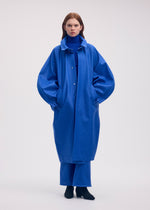A model wears the ISSEY MIYAKE HANG OR CARRY coat.