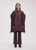 A model wears the ISSEY MIYAKE HANG OR CARRY coat.