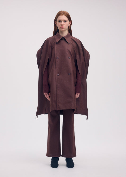 A model wears the ISSEY MIYAKE HANG OR CARRY coat.