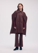 A model wears the ISSEY MIYAKE HANG OR CARRY coat.