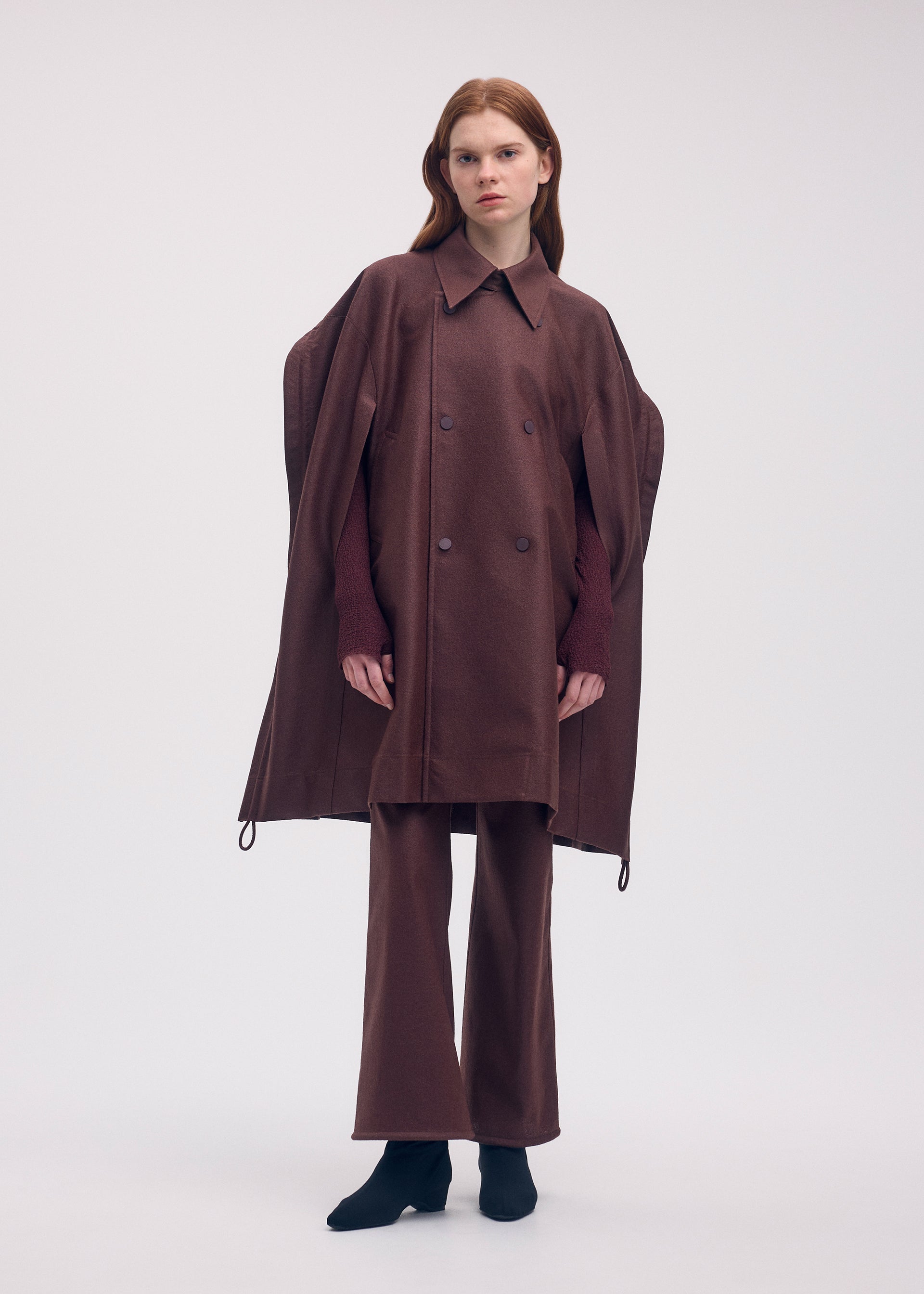 A model wears the ISSEY MIYAKE HANG OR CARRY coat.