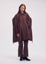 A model wears the ISSEY MIYAKE HANG OR CARRY coat.