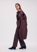 A model wears the ISSEY MIYAKE HANG OR CARRY coat.