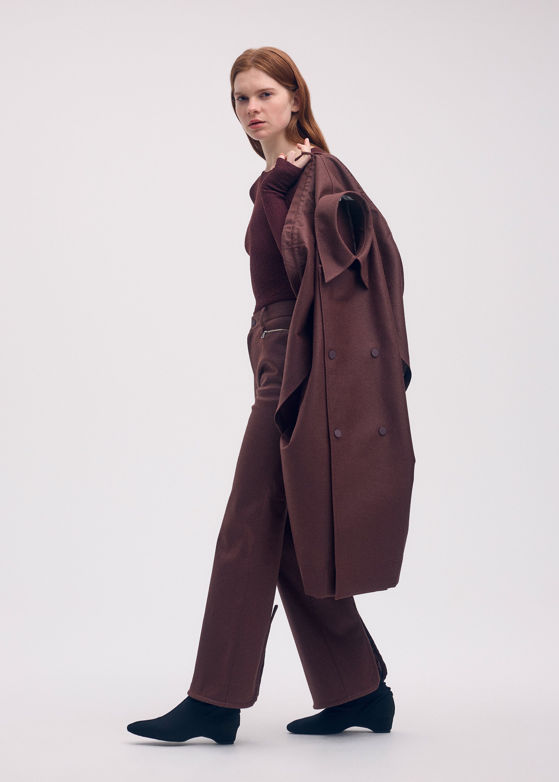 A model wears the ISSEY MIYAKE HANG OR CARRY coat.