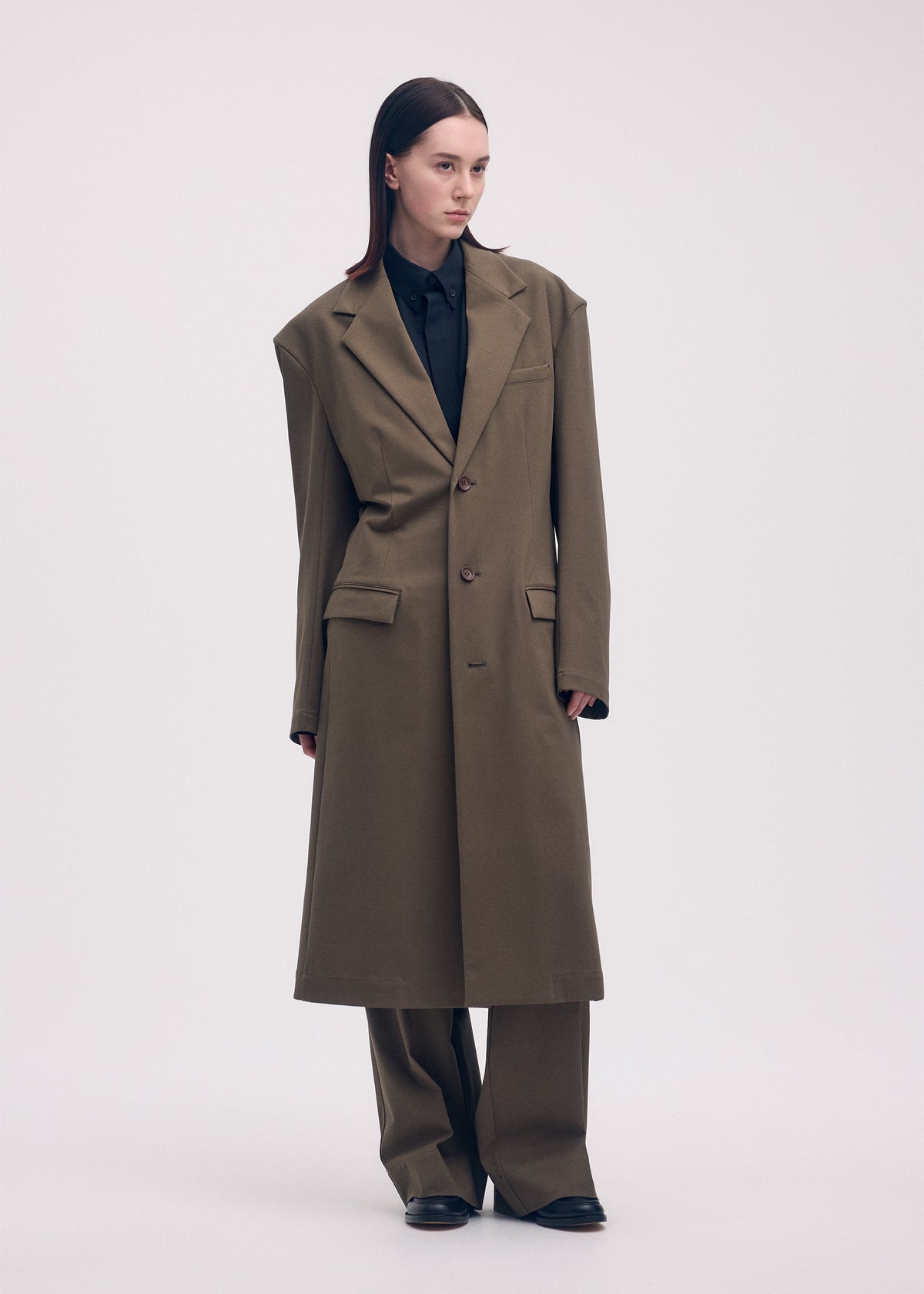 A model wears the ISSEY MIYAKE SIMPLE ENSEMBLE jacket.