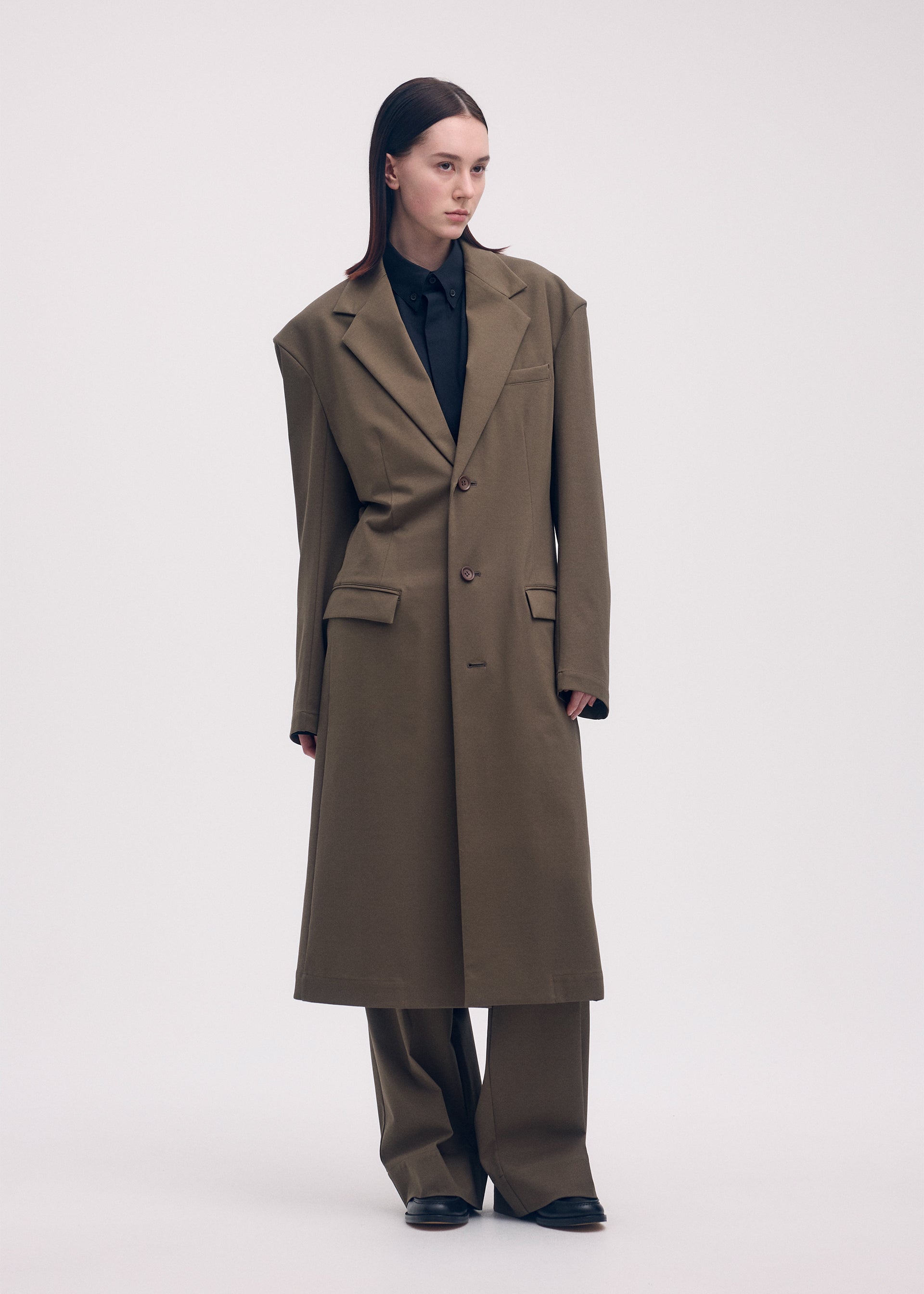 A model wears the ISSEY MIYAKE SIMPLE ENSEMBLE jacket.