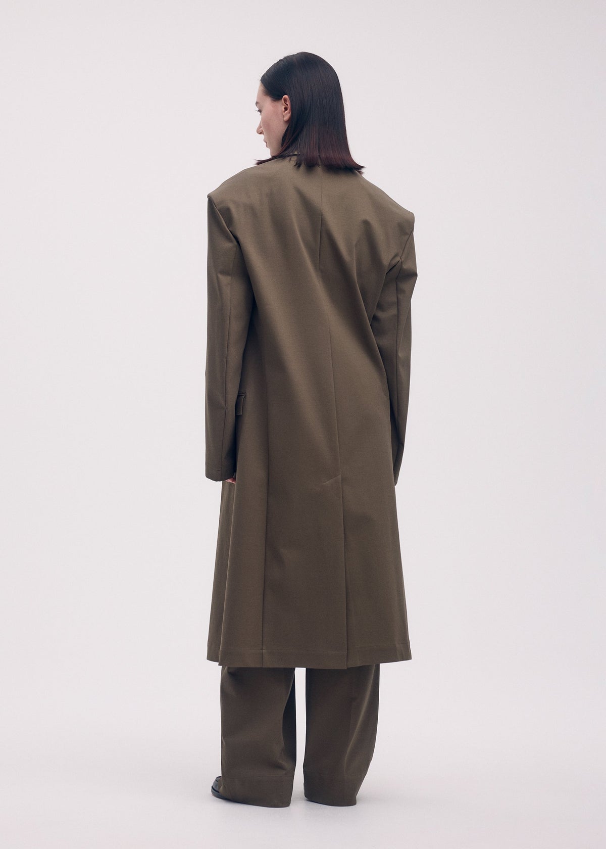 A model wears the ISSEY MIYAKE SIMPLE ENSEMBLE jacket.