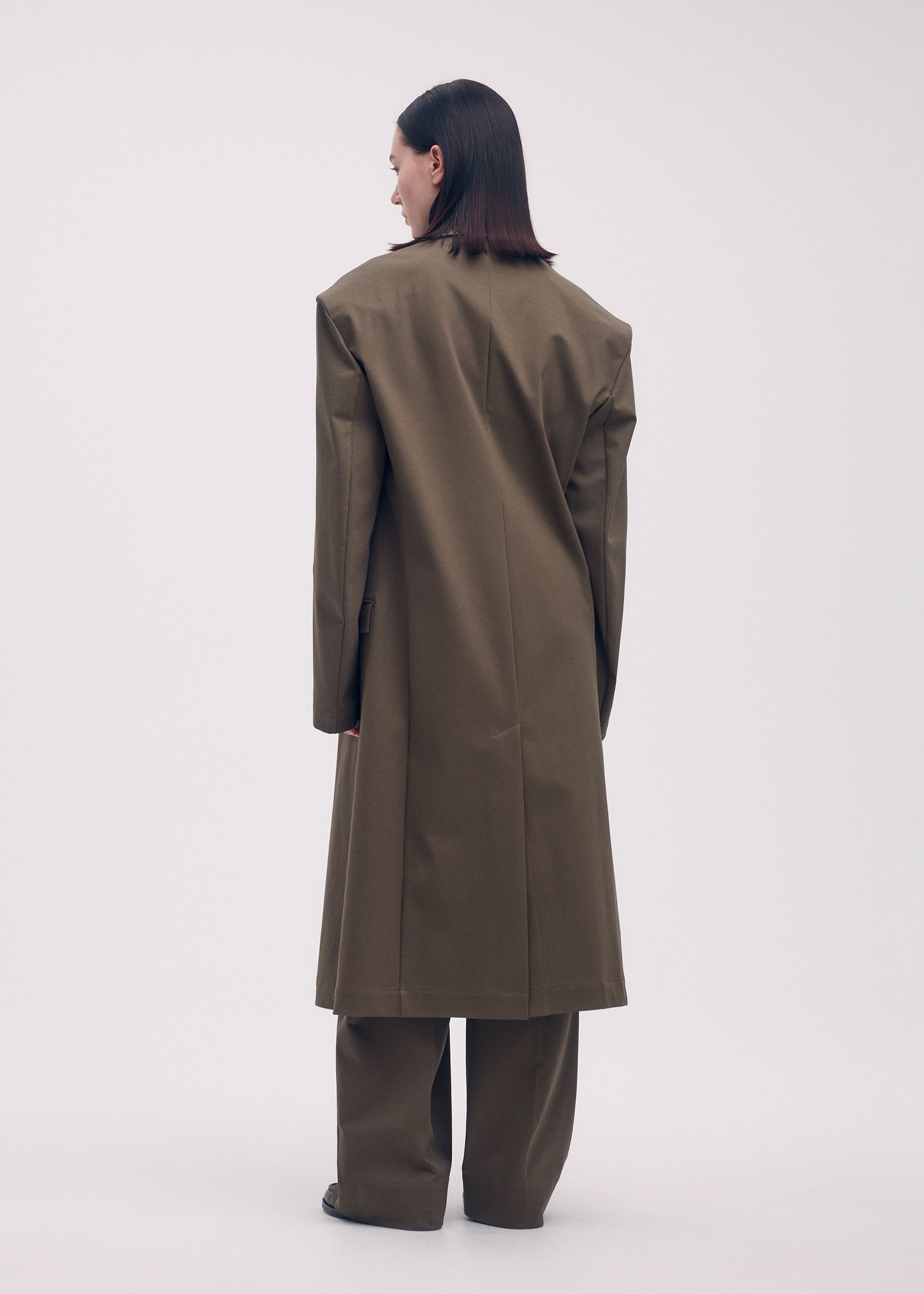 A model wears the ISSEY MIYAKE SIMPLE ENSEMBLE jacket.