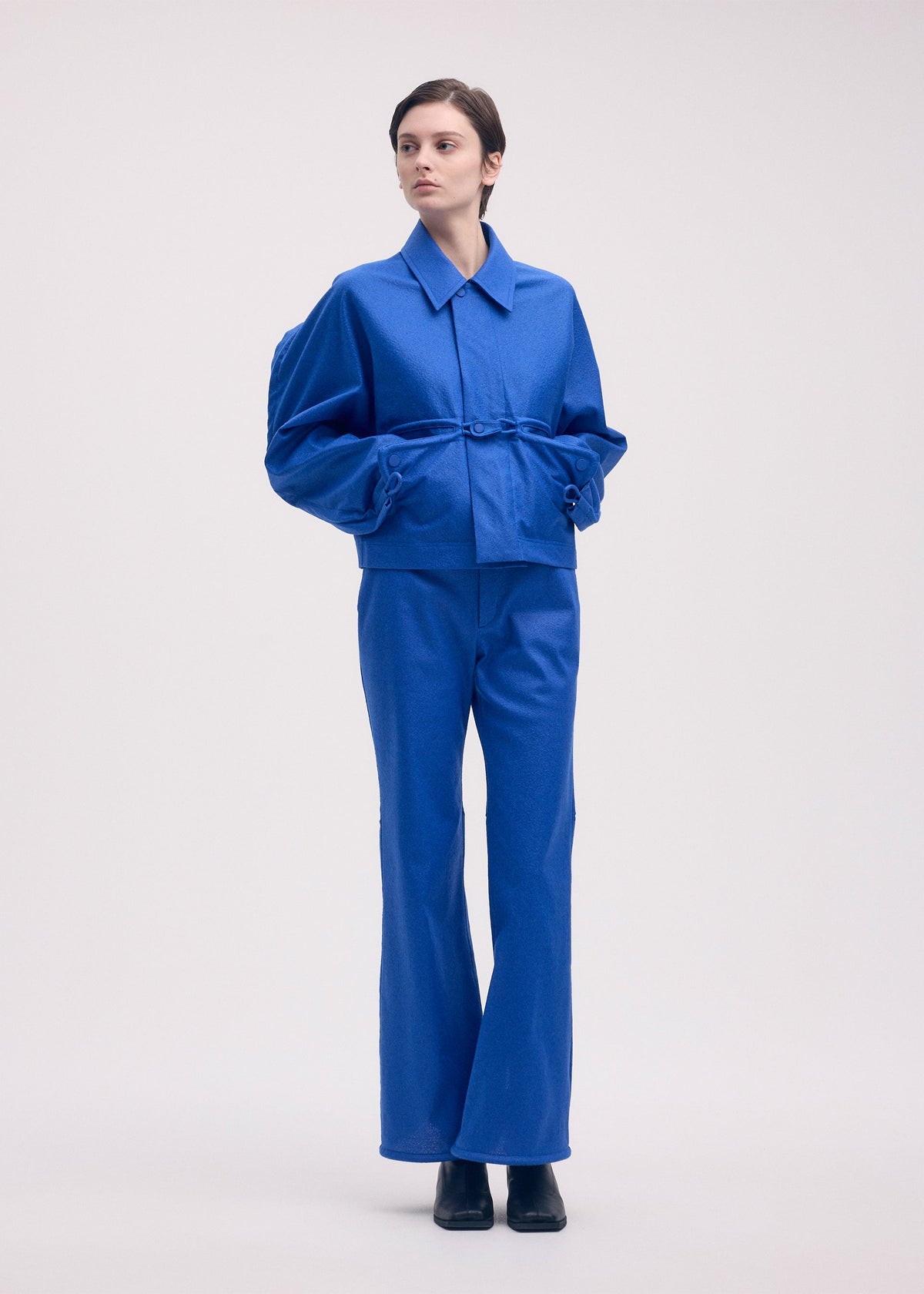 A model wears the ISSEY MIYAKE HANG OR CARRY jacket.