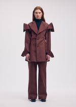 A model wears the ISSEY MIYAKE LEFT UNDONE jacket.