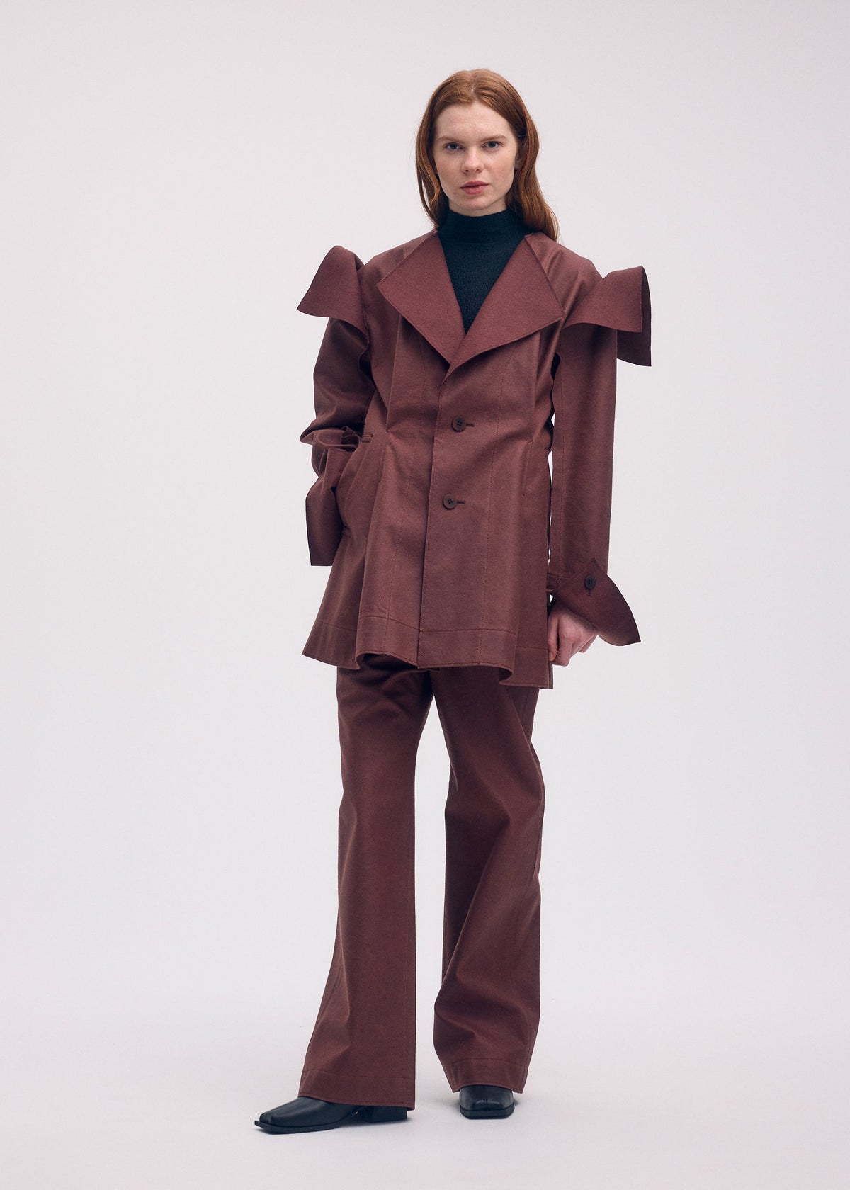 A model wears the ISSEY MIYAKE LEFT UNDONE jacket.