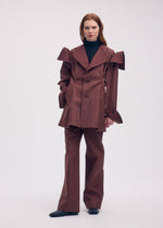 A model wears the ISSEY MIYAKE LEFT UNDONE jacket.